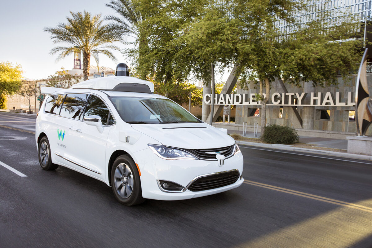 Waymo driverless car passing Chandler City Hall on major road