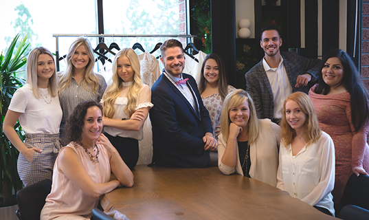 Staff of wedding dress company Anomalie pose for a photo.