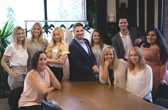 Staff of wedding dress company Anomalie pose for a photo.