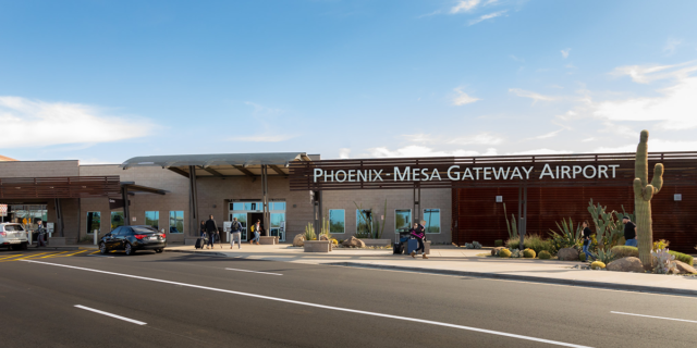 Pedestrians walk through the entrance of Phoenix-Mesa Gateway Airport