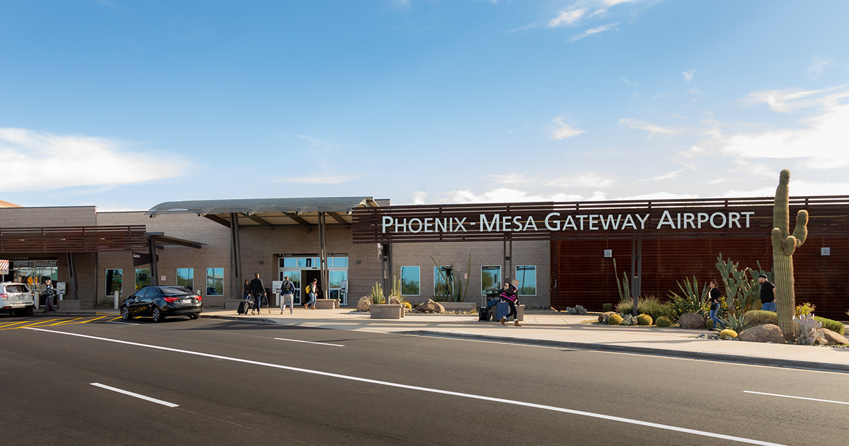 Pedestrians walk through the entrance of Phoenix-Mesa Gateway Airport