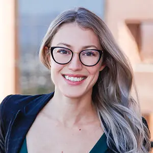 Headshot of Serena Remy in downtown phoenix with skyline reflection in background