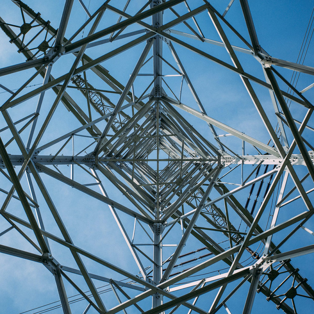 Upward view of large metal electric power pole