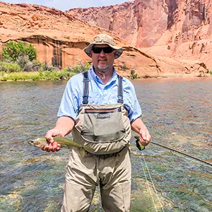 Brad Smidt holding a fish in the lake