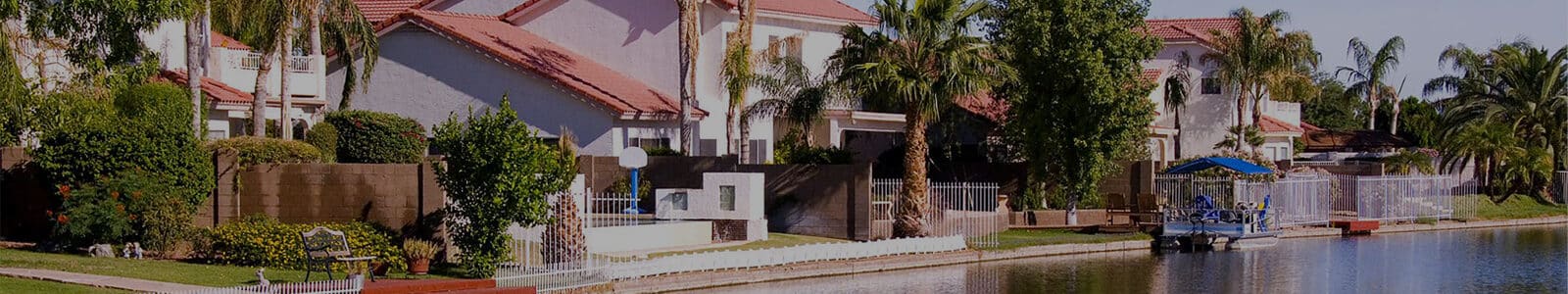 Suburban houses on a river with trees in the daytime