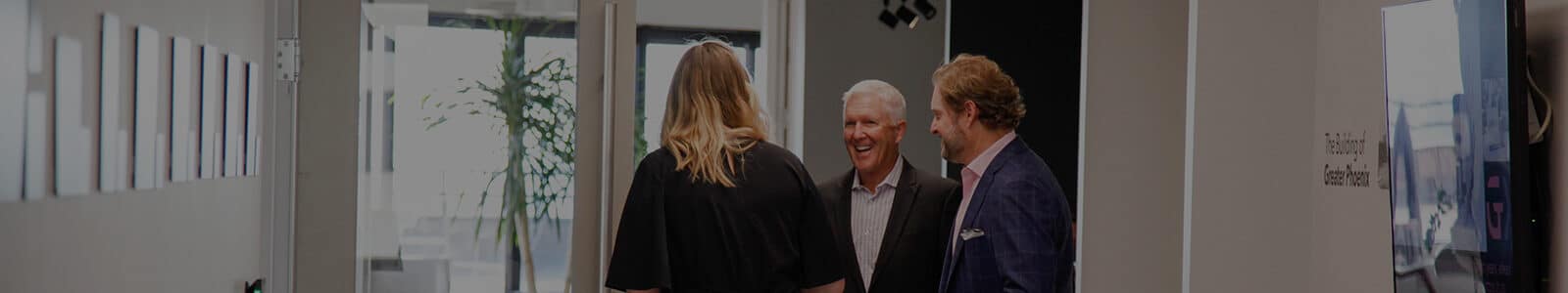 Staff and board members entering a meeting room at the GPEC office