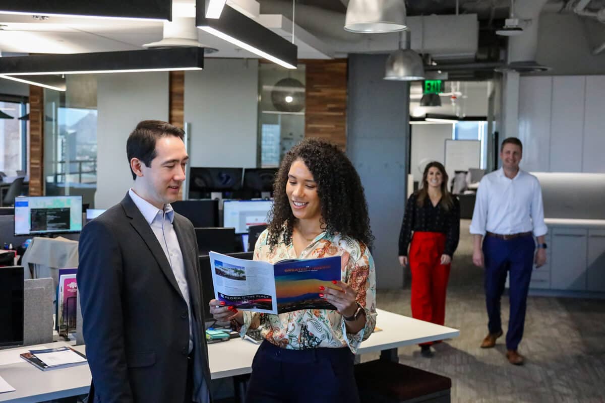 Two pairs of colleagues in conversation at the office