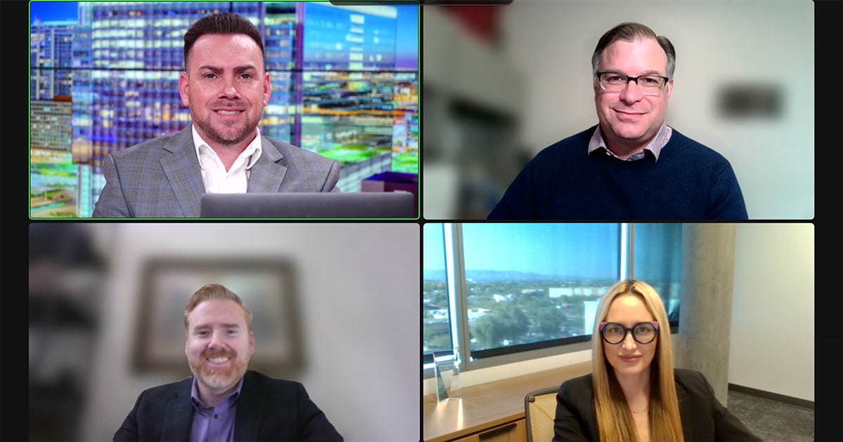 Three men and one woman are displayed on a split-screen Zoom panel.