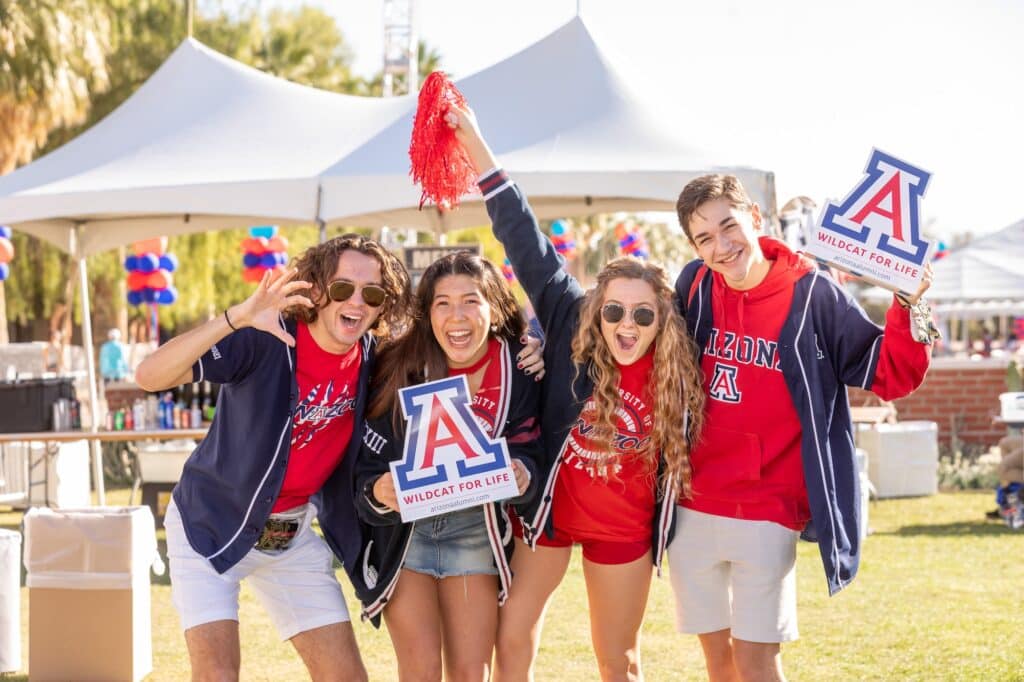 Students posing outside for a picture wearing UArizona tshirts.