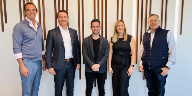 Five people post in a straight line for a picture at the GPEC office.