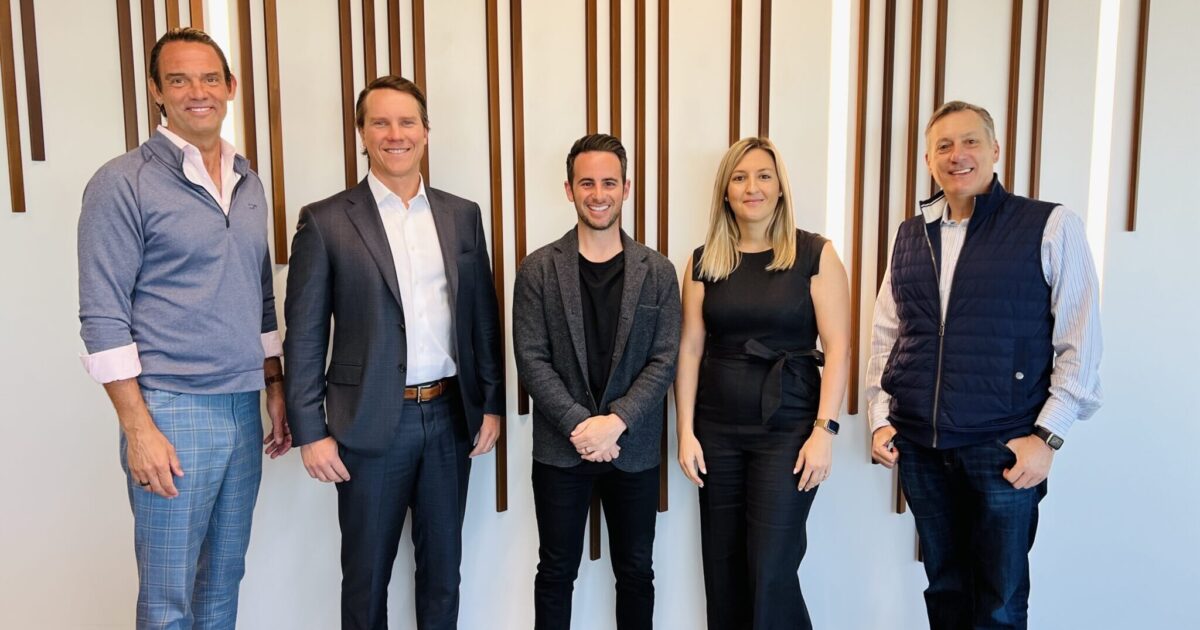 Five people post in a straight line for a picture at the GPEC office.