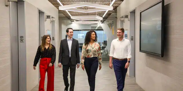 GPEC employees walk in office hallway