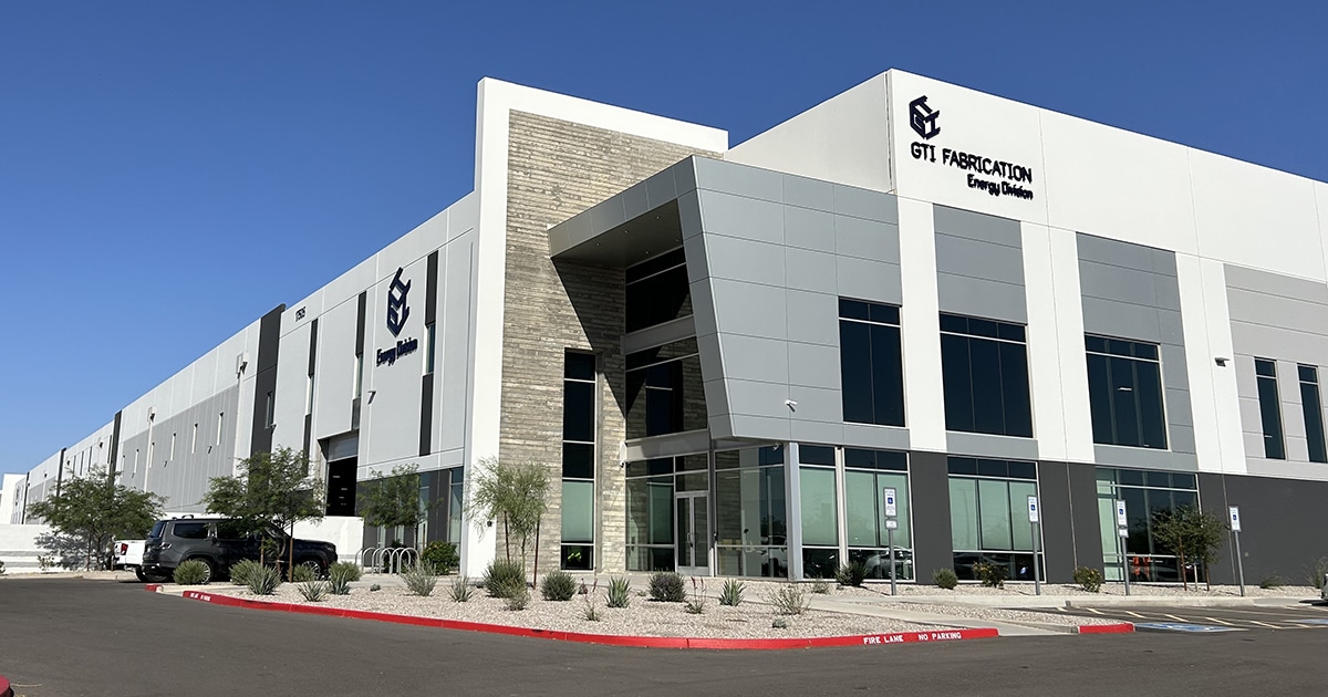 The exterior of a large building with two GTI Fabrication logos.