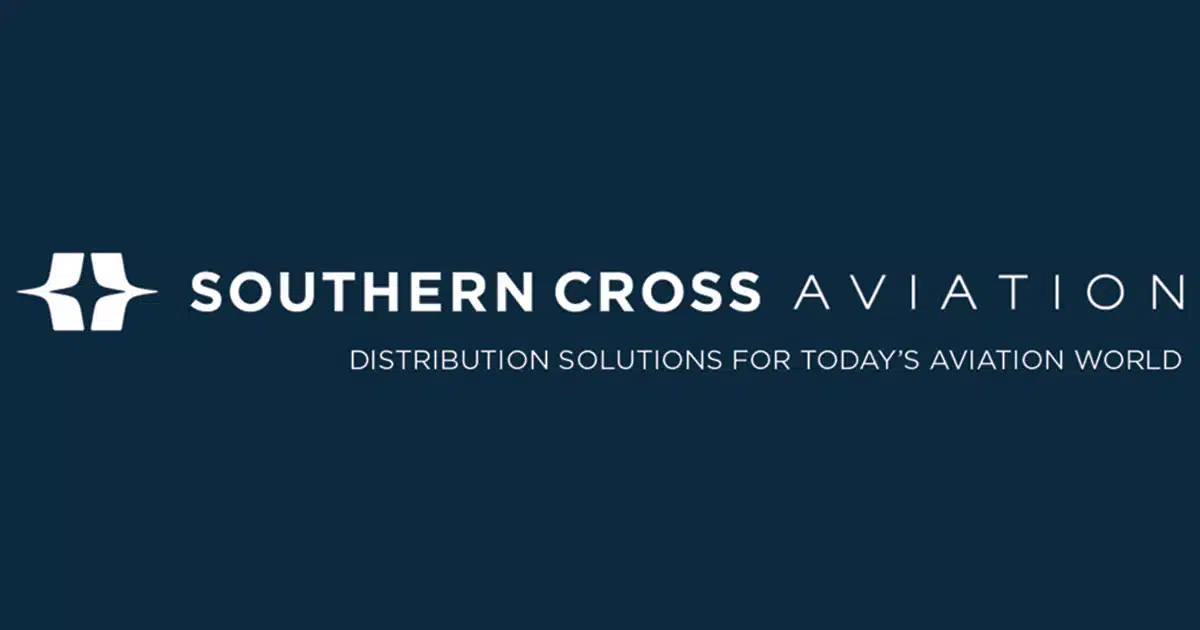 A dark blue background with Southern Cross Aviation written, first two words in white and third word in light blue. The white company insignia is on the lefthand side and motto beneath.